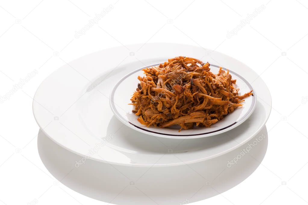 Traditional barbecue pulled pork on plate isolated on white background. Culinary meat eating.