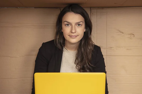 business woman talks on the phone in a tight cardboard box