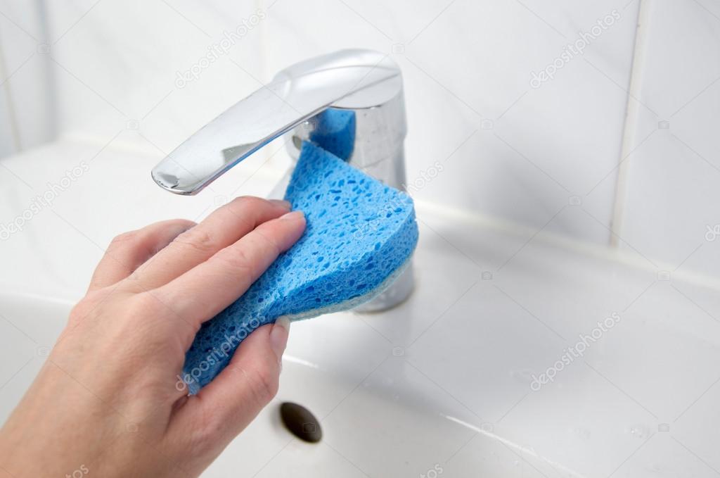 cleaning the bathroom with a sponge