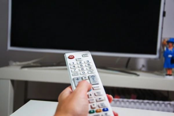Hand with white remote — Stock Photo, Image