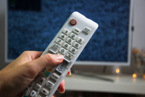 Hand with white remote — Stock Photo, Image