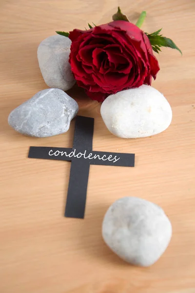 Condolences written on a black cross — Stock Photo, Image
