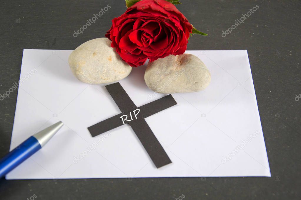 RIP  written on a black cross