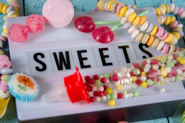 Sweets written on a lightbox — Stock Photo, Image