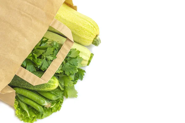 Paper bag of different healthy green vegetables on dark backgrou — Stock Photo, Image