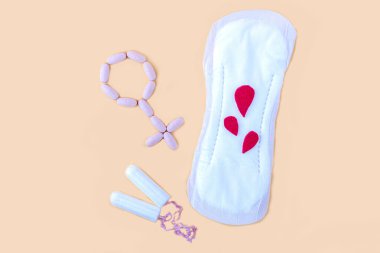 Protective menstrual pad, cotton tampons and gender symbol made from pink pain pills. The concept of women gynecological health and intimate hygiene. Flat lay, copy space for text, close up clipart