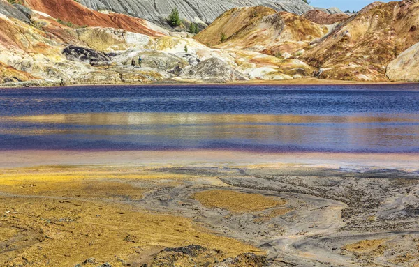 Landscape like a planet Mars surface. Ural refractory clay quarries. Nature of Ural mountains, Russia. Solidified red-brown black Earth surface for screensaver for desktop, banner, cover.