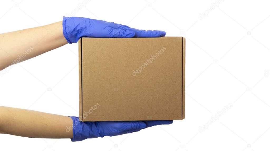 Safe contactless Delivery service during quarantine. Young woman hand in gloves holds box isolated on white. Stay home, online shopping during coronsavirus outbreak. Copy space for text, banner