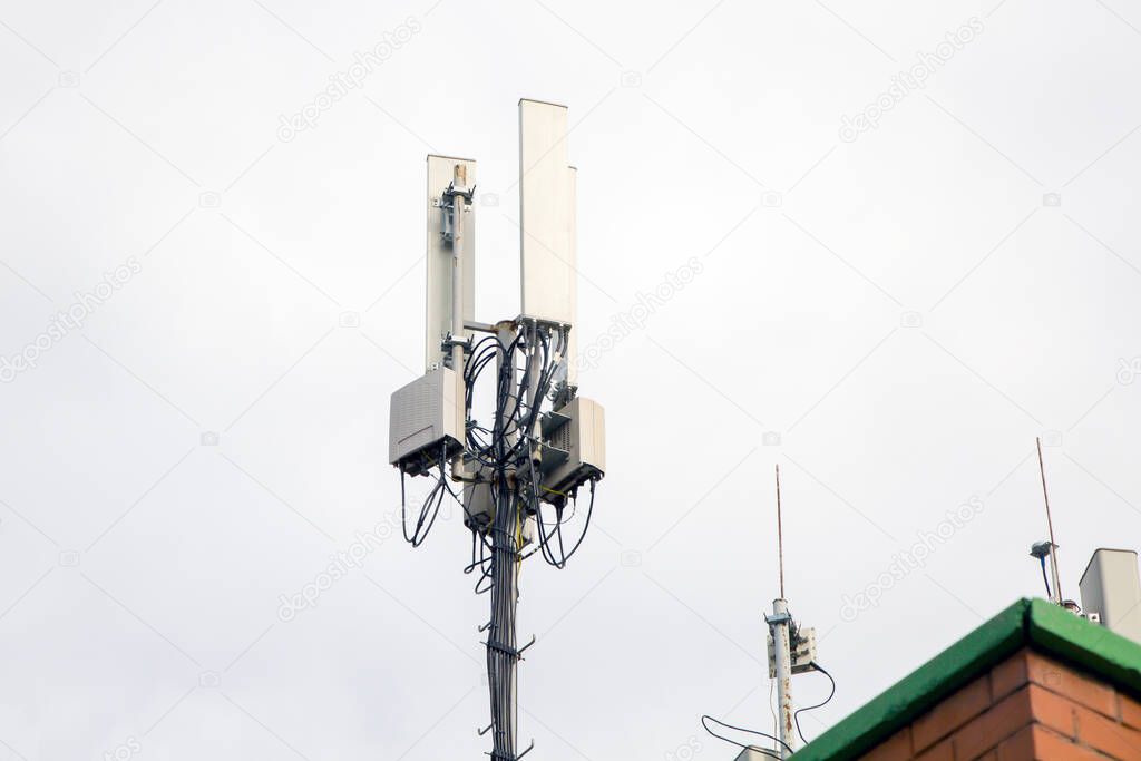 Telecommunication tower of 4G andcellular tower of 5G on the roof of a residential building. Radio tower with 5G network