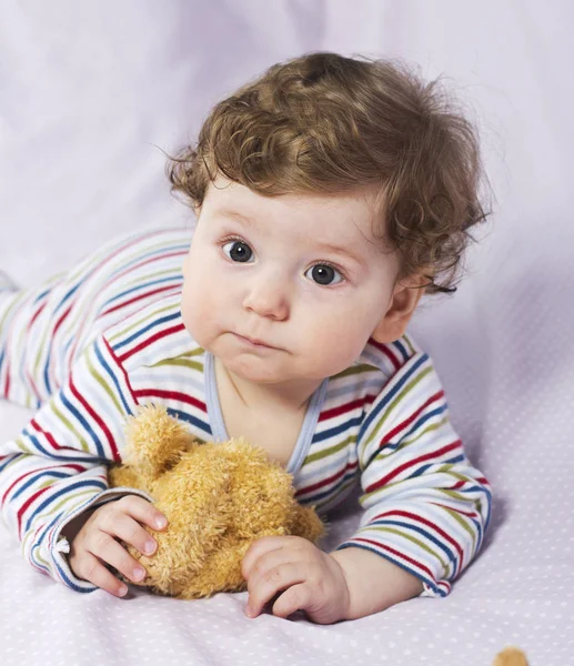 The little boy in the crib with toys. The child in the home — Stock Photo, Image