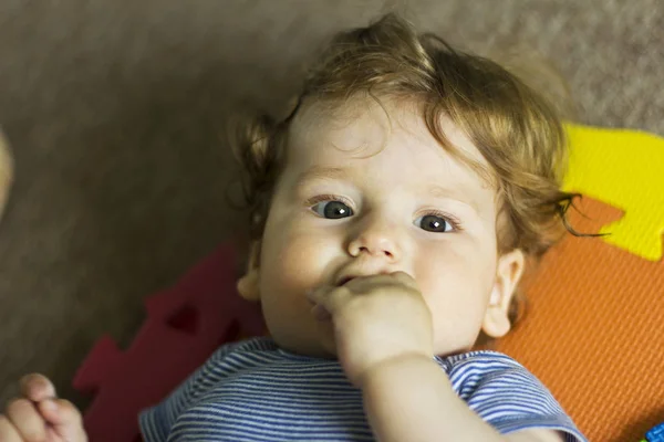 The kid plays with toys at home . Portrait of a boy at home — Stock Photo, Image