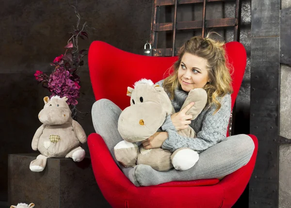Smiling Young Girl Sitting Soft Toys Red Chair — Stock Photo, Image
