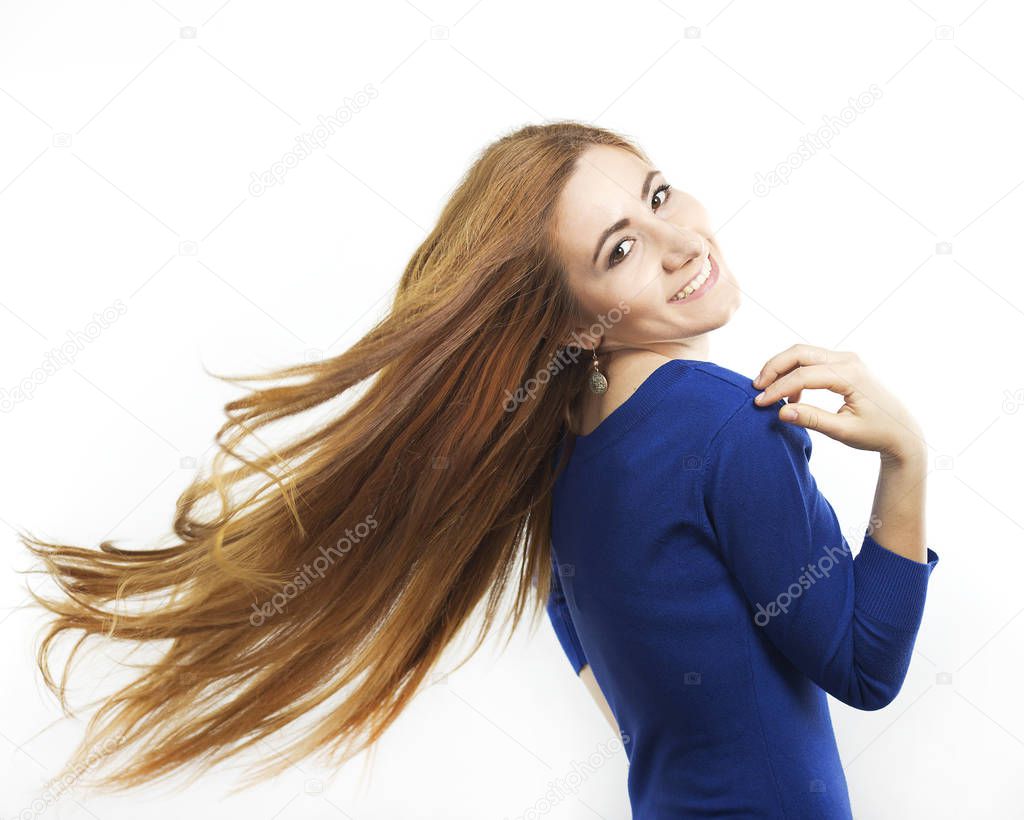 Smiling girl with long flying hair. Portrait of a redheaded girl. Beautiful happy woman