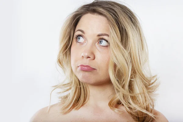 Isolated portrait of an upset woman. Sad female face. Young beautiful woman on a white background.