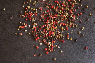 Siyah arka planda kırmızı, yeşil ve siyah biber. Biber. 