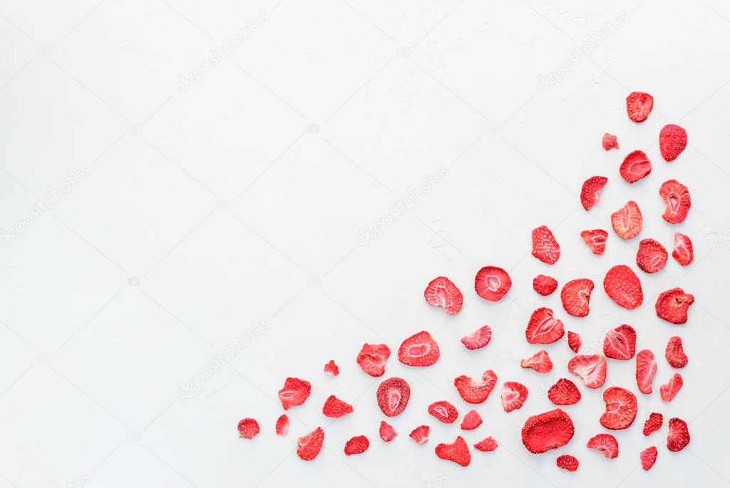 Sliced sublimated strawberries on a white background. Horizontal orientation, copy space.