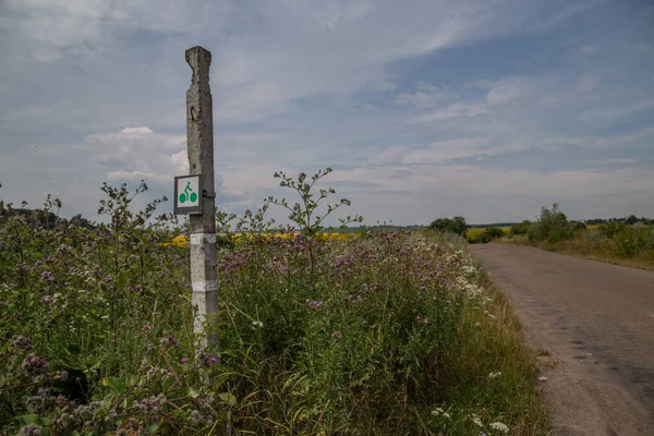 cycle route sign on a pillar near the field