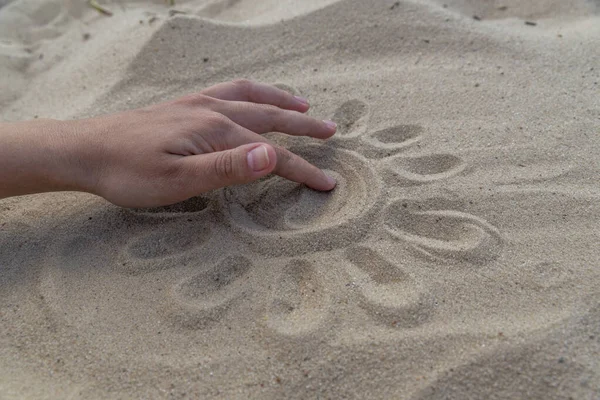 the sun on the sand is drawn by hand