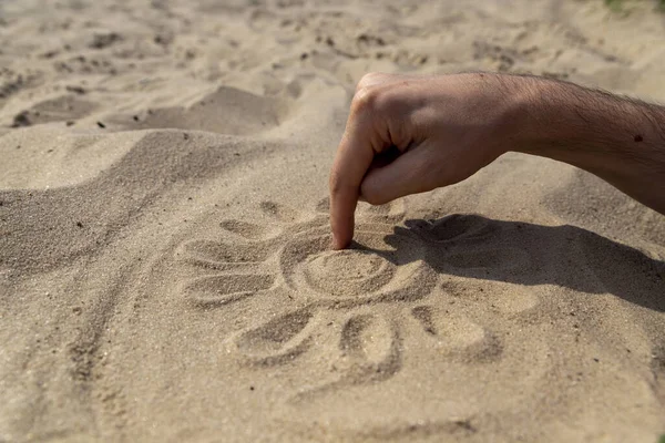 the sun on the sand is drawn by hand