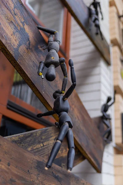 black wooden dummies for drawing in different poses on windows