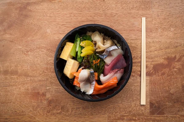 Japanese food Tekka Don take away on wooden background — Stock Photo, Image