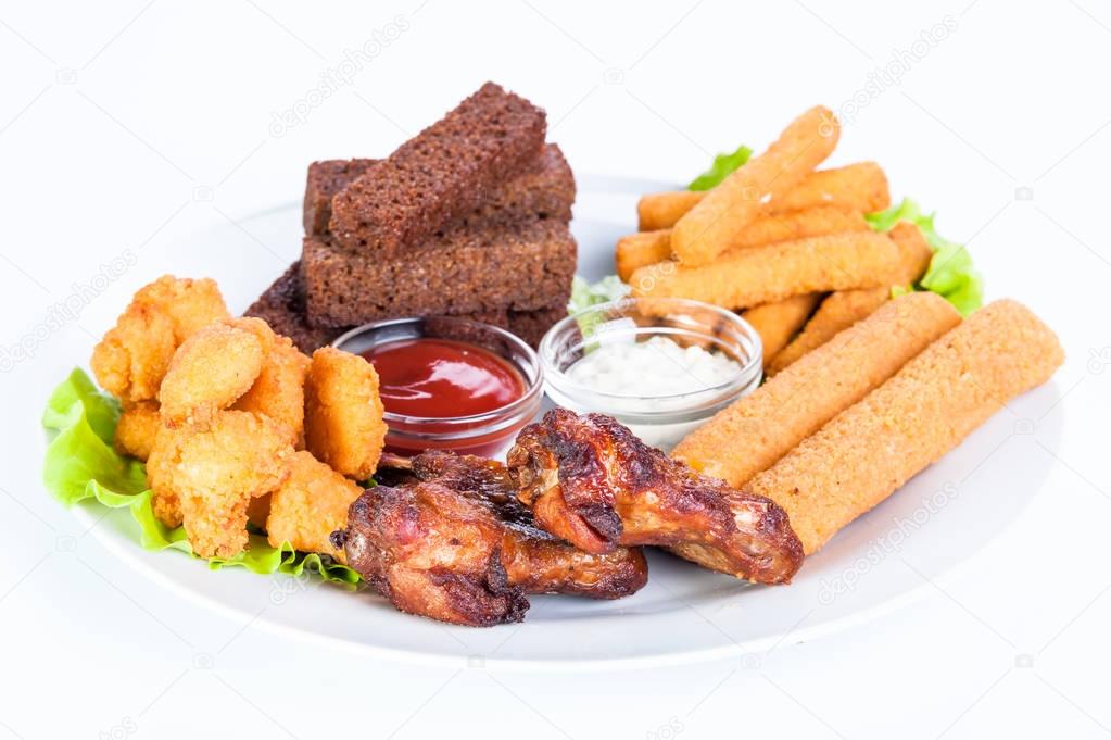 Assorted hot snacks. Chicken nuggets, roasted cheese, croutons, onion rings with ketchup