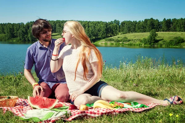 Young boy and girl on a picnic by the lake — Stock Photo, Image
