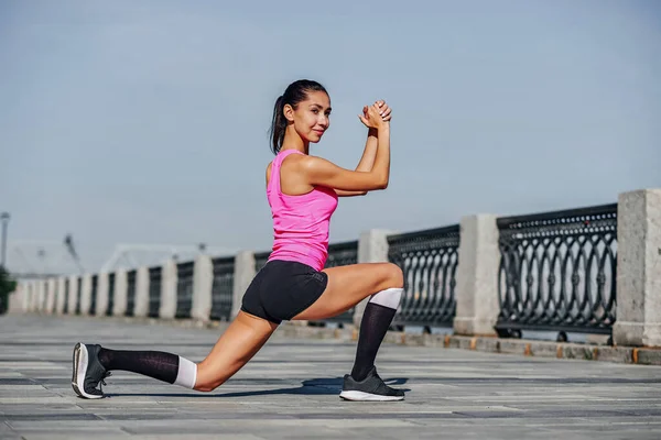 Fitness jovem mulher esticando as pernas após a corrida. ao ar livre retrato esporte — Fotografia de Stock