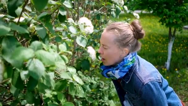 Frau niest vom blühenden Baum. Konzept: saisonale Allergie — Stockvideo