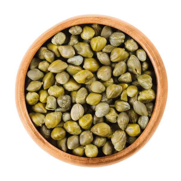 Capers in wooden bowl on white background — Stock Photo, Image