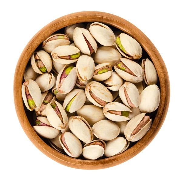 Roasted pistachio seeds with shell in bowl over white — Stock Photo, Image