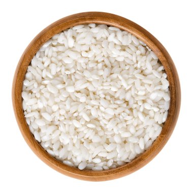 Arborio risotto rice in wooden bowl over white clipart