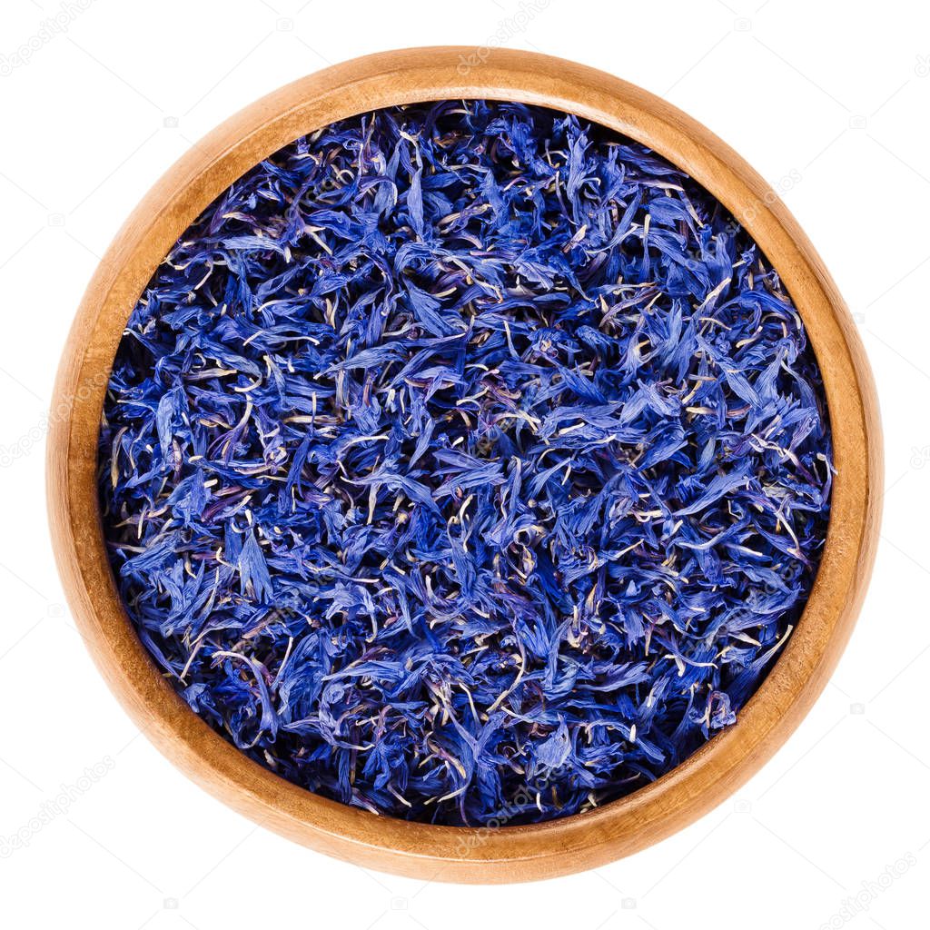 Dried cornflowers in wooden bowl over white