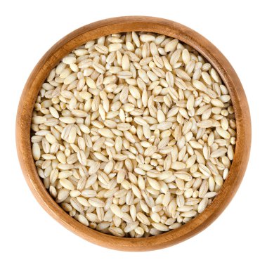 Processed pearl barley in wooden bowl over white clipart