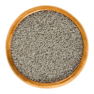 Ahşap gri haşhaş tohumları üzerinde beyaz kase