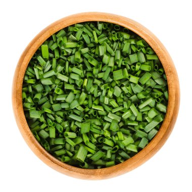 Chopped chives in wooden bowl over white clipart