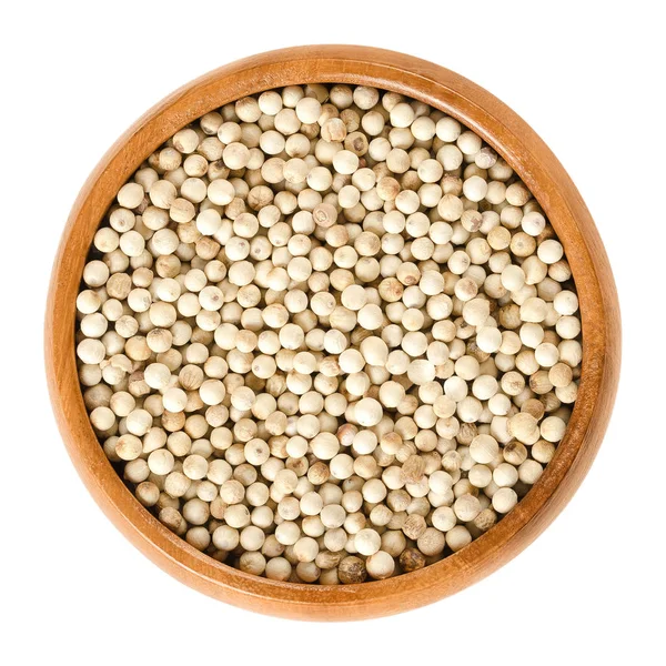 White pepper in wooden bowl over white — Stock Photo, Image