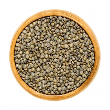 Puy lentils in wooden bowl over white clipart