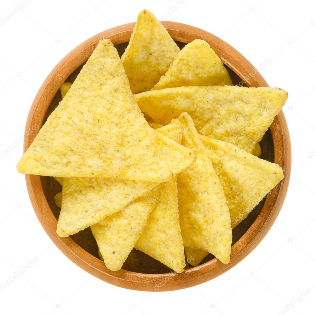 Tortilla chips in wooden bowl over white