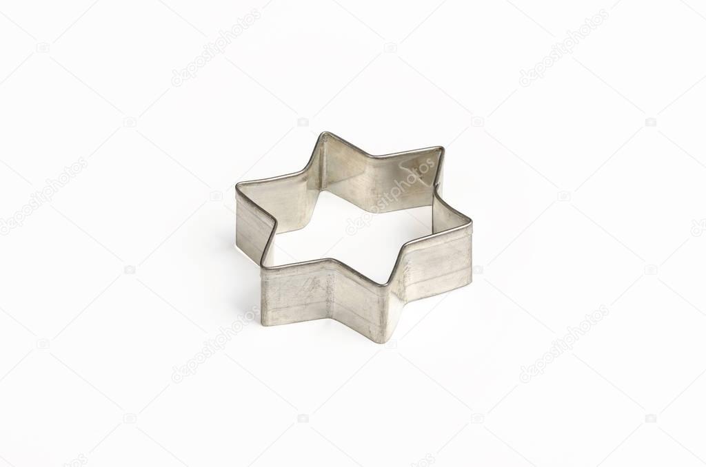 Star shaped Christmas cookie cutter over white
