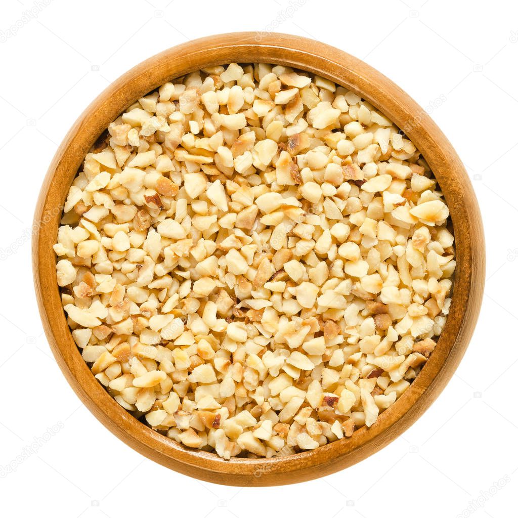 Hazelnut kernels, roughly chopped, in wooden bowl