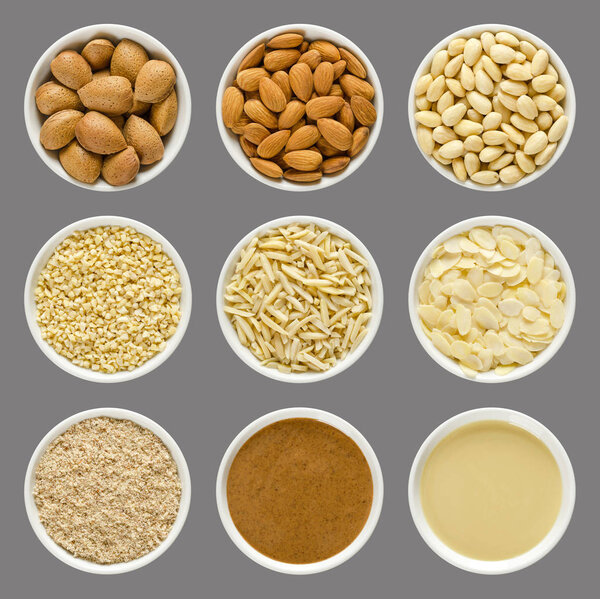 Almonds, whole nuts and processed, in white bowls