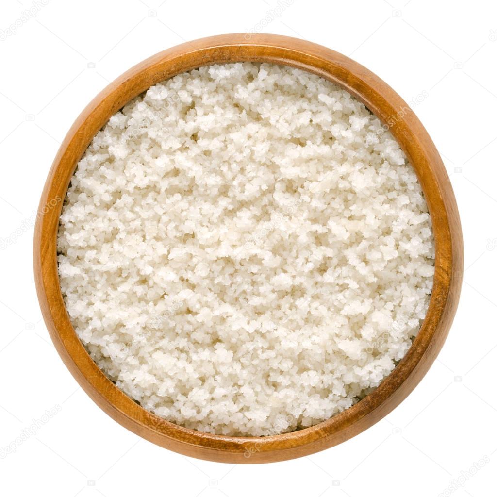 Antlantic sea salt in wooden bowl over white