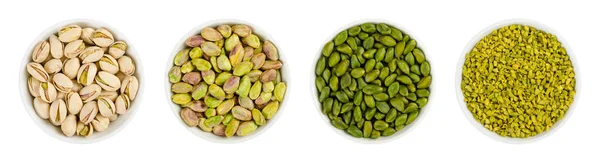 Pistachos en cuencos de porcelana blanca sobre blanco —  Fotos de Stock