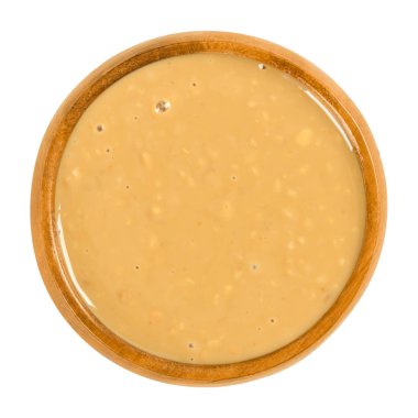 Ahşap kase beyaz içinde gevrek fıstık yağı