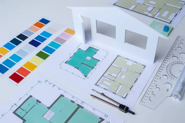 Development of the cottage project. Creation of building plans of the building. Choice of color scheme of the new house. Table in the architectural and construction Bureau. The concept of a new home.