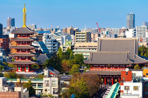 Japan. Tokyo. View of Asakusa temple from a height. Temples Of Japan. Shinto. Tokyo Attractions. Japanese architecture. Iconic buildings of Japan. Red temple among residential buildings in Tokyo.