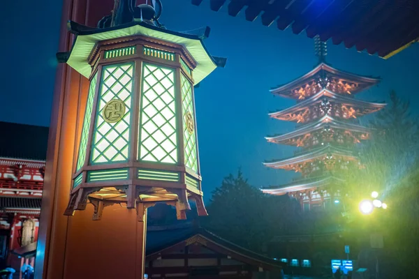 Japan. Street lamp on the background of the temple in Tokyo. Lantern on Asakusa street. Asakusa Pagoda in Japan. Lantern with a swastika. Sensoji Temple in Tokyo. Buddhist pagoda in night Japan.
