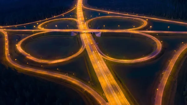 Road junction at night. Road junction glows at night. Road const