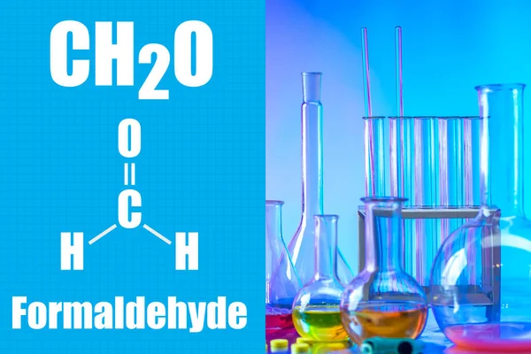 Formaldehyde. CH2O. Test tubes next to safety glasses. Multi-colored liquids on a laboratory assistant\'s desk. Plastic manufacturing. Formaldehyde-based plastic manufacturing. Light industry. Resins